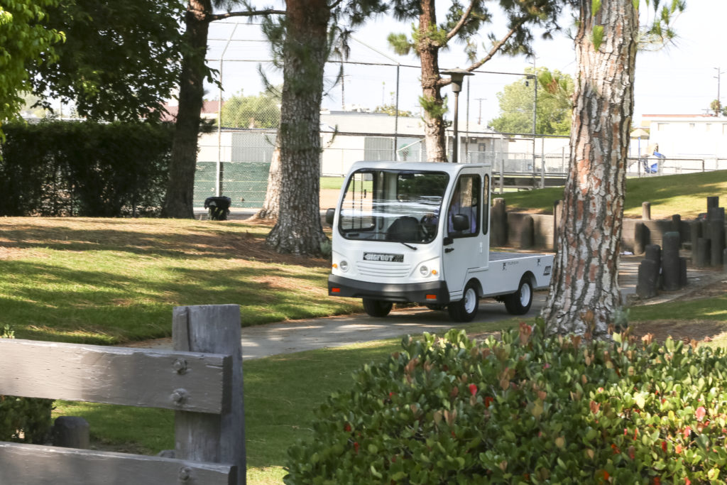 White utility vehicle in a park